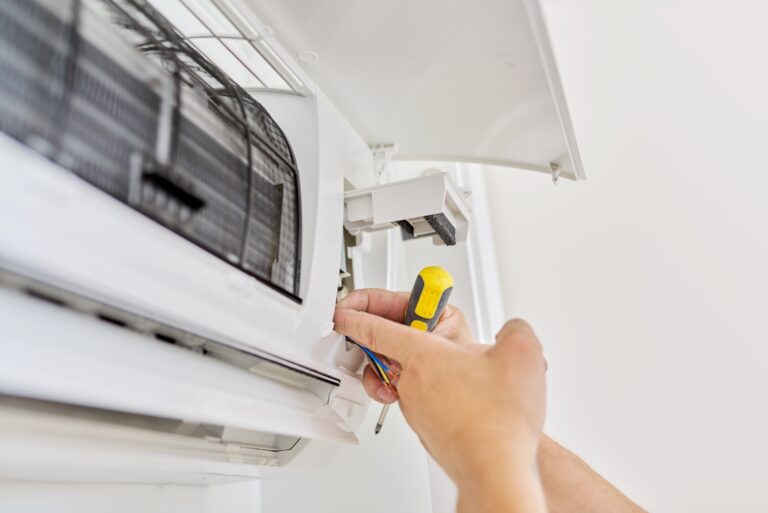 Installing an air conditioner in an apartment office, close-up of an engineer hand